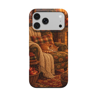 Cozy Reading Nook phone case — armchair by the fire with books, cocoa and a sleeping cat, MagSafe iPhone case, front view