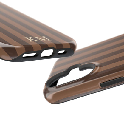 Close-up of printed initials on a brown striped phone case