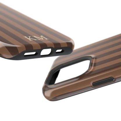 Monogrammed brown stripe phone case in hand