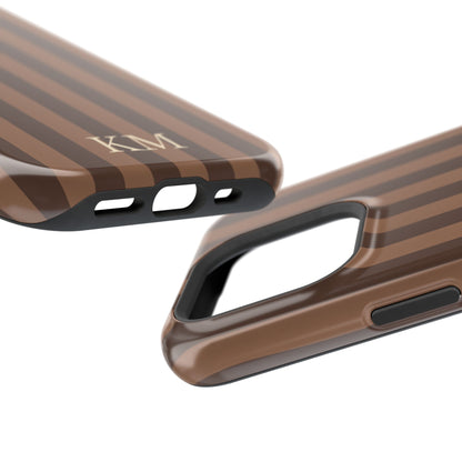 Monogrammed stripe phone case held in one hand