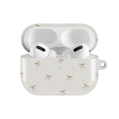 Taupe Bows AirPods case — hard-shell earbuds cover, open front view