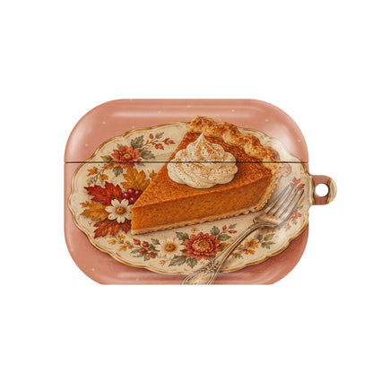 Pumpkin Pie Slice AirPods case — slice of pumpkin pie with whipped cream on a floral plate, closed front view