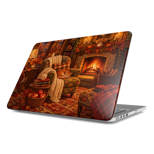 Cozy Reading Nook MacBook case — armchair by the fire with books, cocoa and a sleeping cat, hard-shell laptop cover, angled lid view