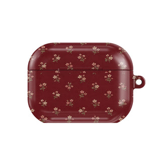 Burgundy Ditsy Floral AirPods case — tiny cream flower sprigs on deep burgundy, closed front view