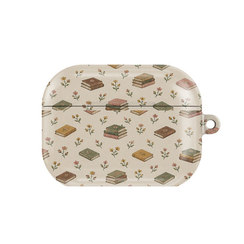 Tiny Books AirPods case — little stacks of vintage books and wildflowers on cream, closed front view