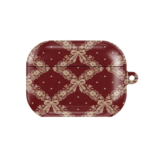 Burgundy Lace AirPods case — blush lace trellis with ribbon bows on burgundy, closed front view
