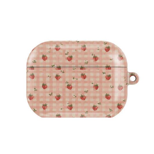 Strawberry Gingham AirPods case — little red strawberries on peach gingham, closed front view