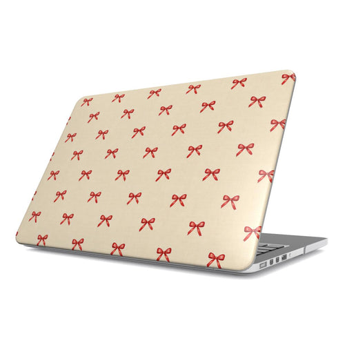 Tiny Red Bows MacBook case — tiny cherry-red bows scattered on soft cream, hard-shell laptop cover, angled lid view