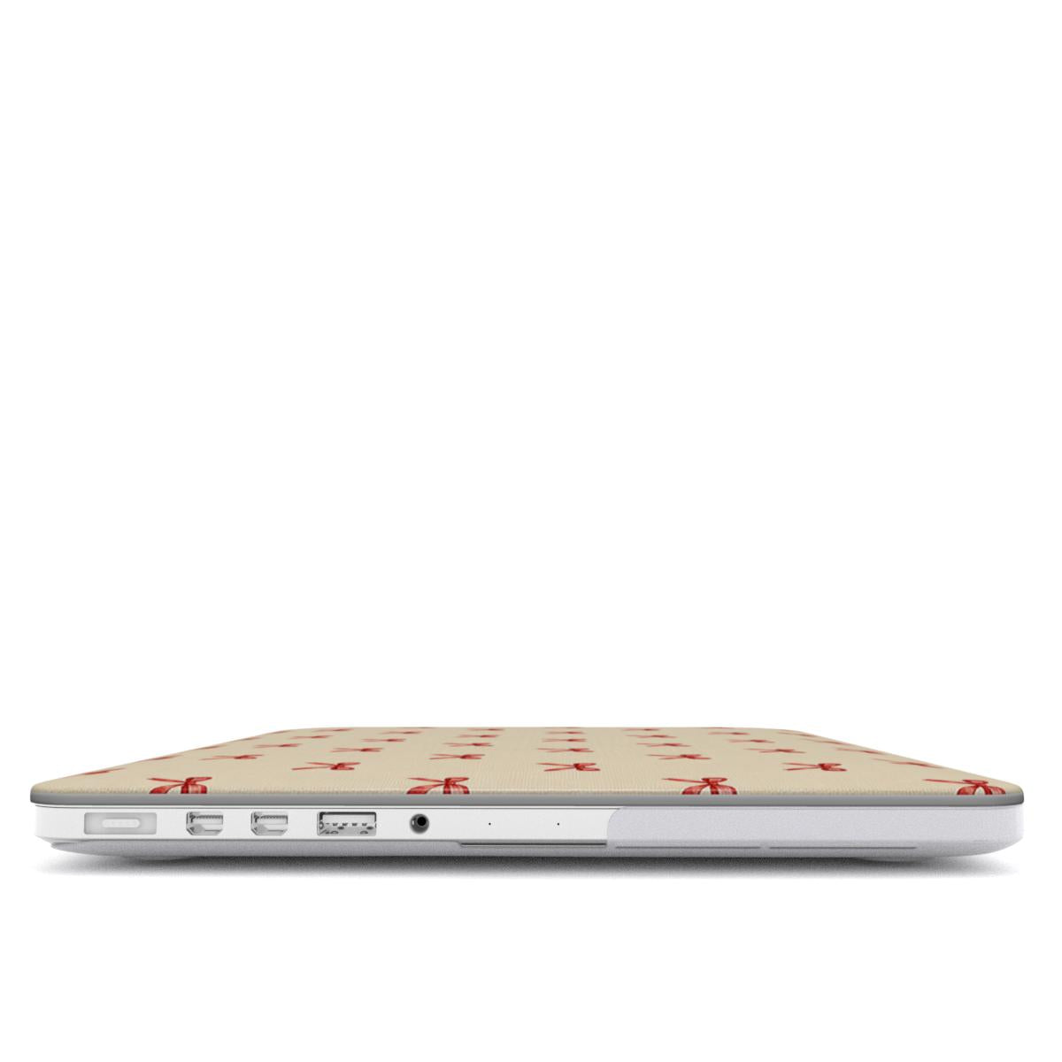 Tiny Red Bows MacBook case — hard-shell laptop cover, side view with ports