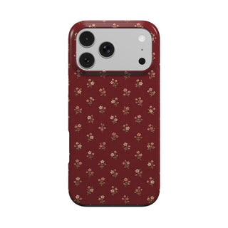 Burgundy Ditsy Floral phone case — tiny cream flower sprigs on deep burgundy, MagSafe iPhone case, front view