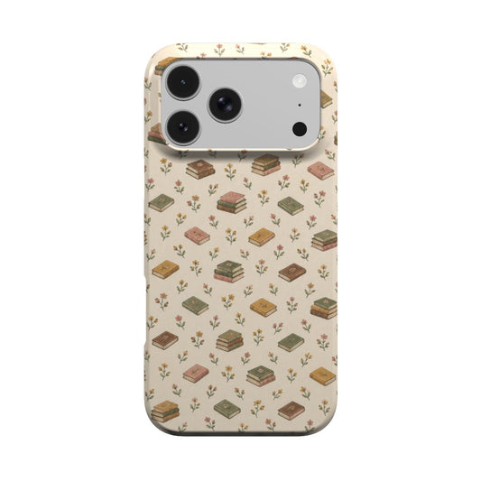 Tiny Books phone case — little stacks of vintage books and wildflowers on cream, MagSafe iPhone case, front view