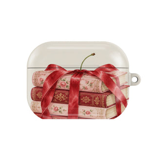 Cherry Bow Book Stack AirPods case — bookish coquette, closed front view
