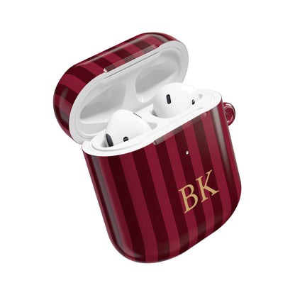 Burgundy stripe AirPods case open with AirPods inside — custom initials