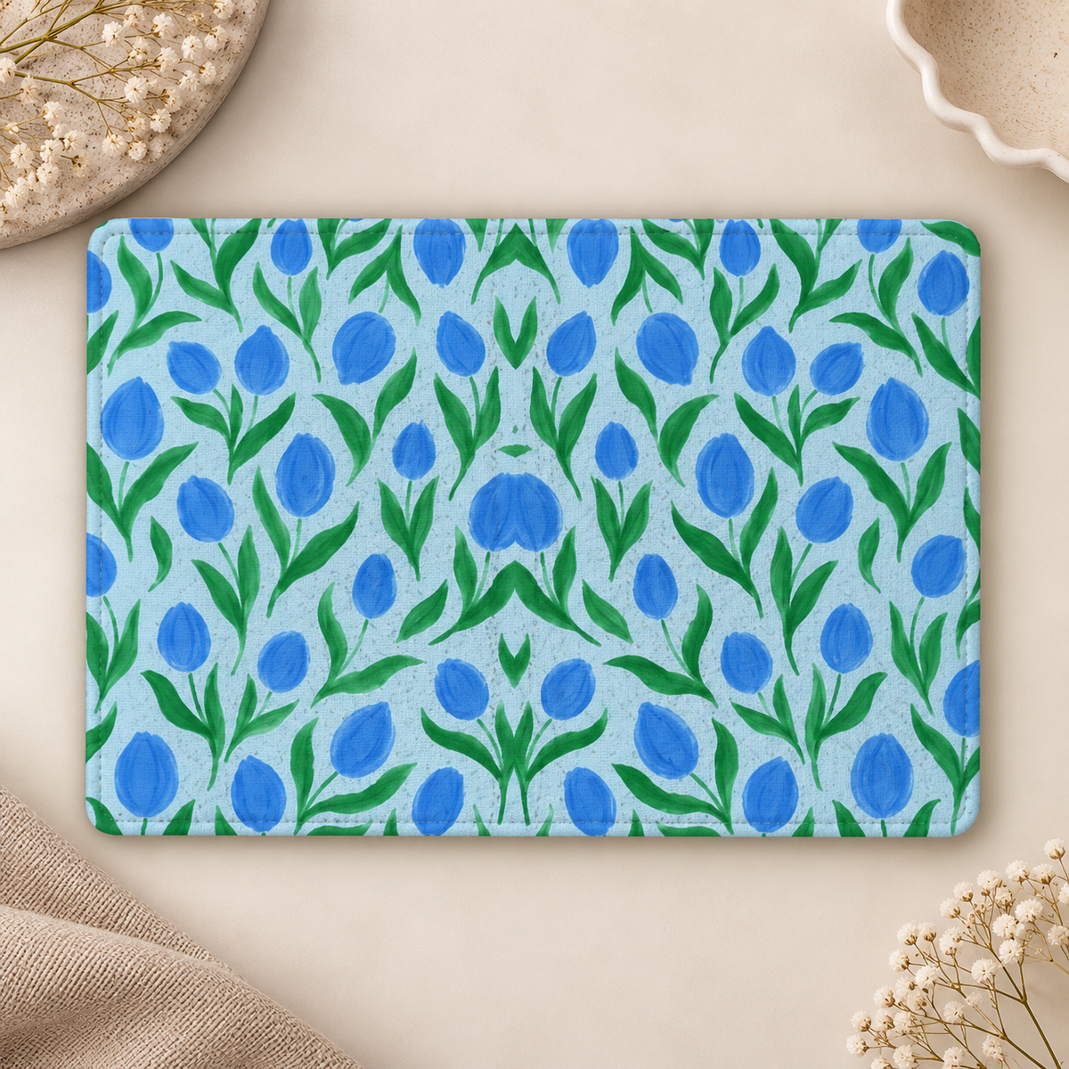 Painted Tulip Kindle case opened flat, front and back — cobalt blue tulips and green leaves on pale blue