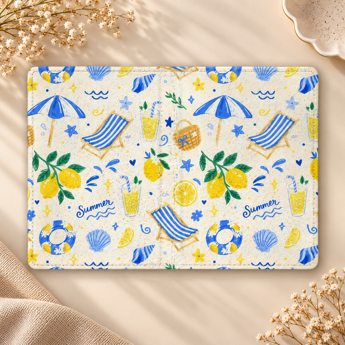 Summer Seaside Kindle case opened flat, front and back — blue umbrellas, deck chairs, shells and lemons on cream