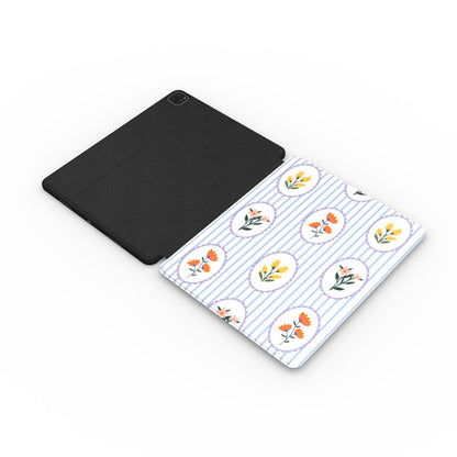 Blue stripe floral cameo iPad case with the Apple Pencil charging in its cutout