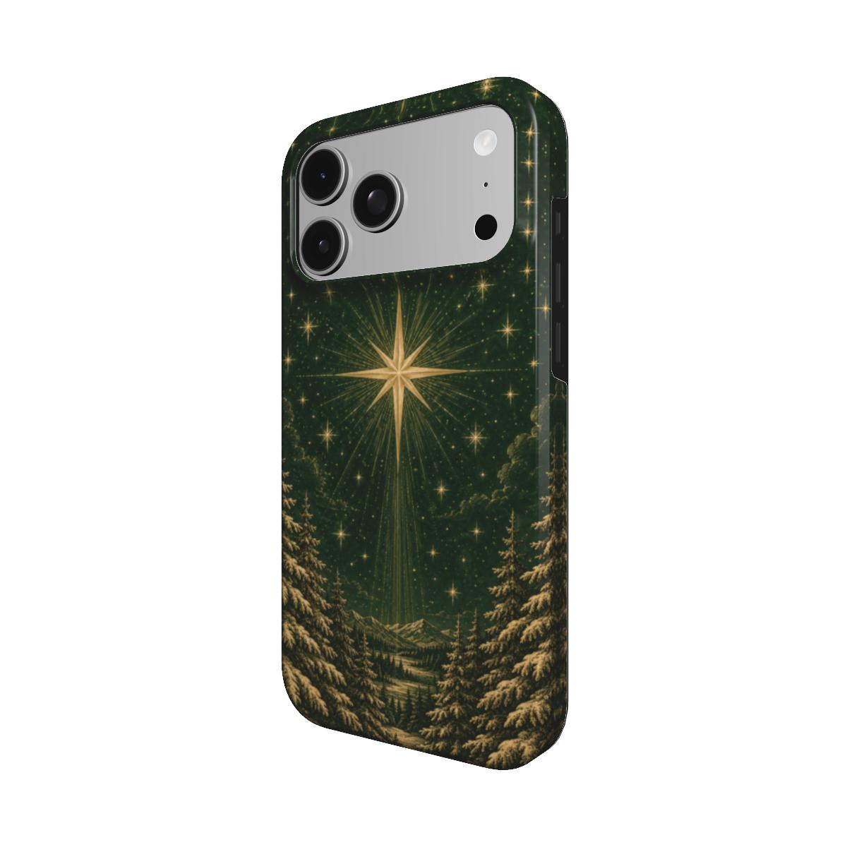 Christmas star iPhone case — gold star over a snowy pine forest on deep green, MagSafe phone case, angled view