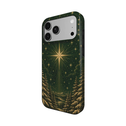 Christmas star iPhone case — gold star over a snowy pine forest on deep green, MagSafe phone case, angled view