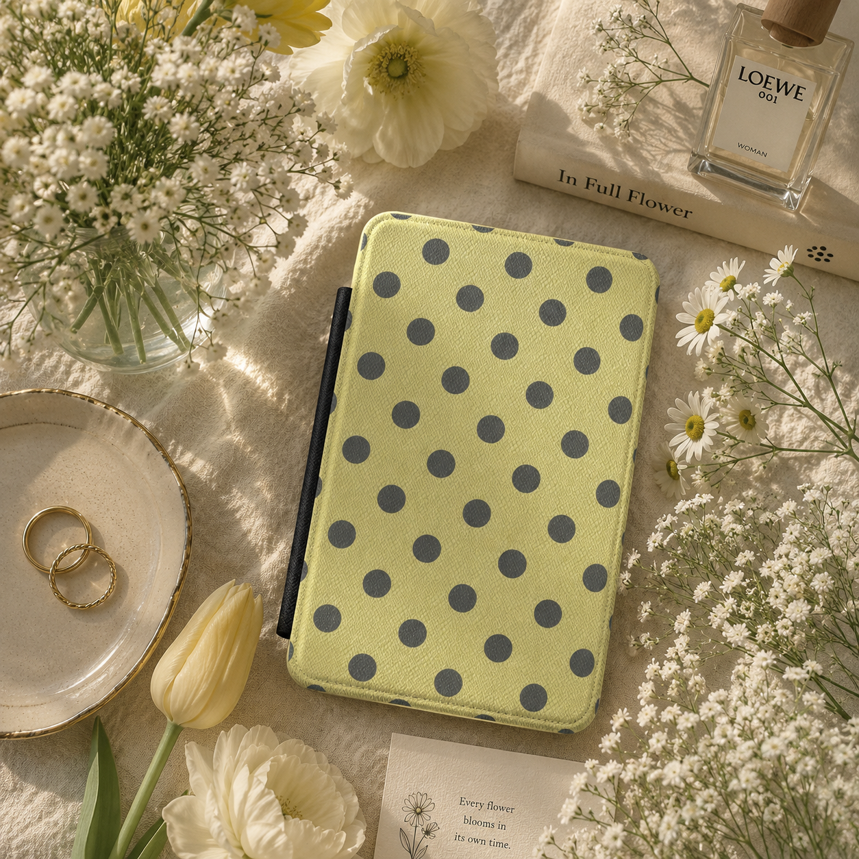 Pale citron Kindle case with charcoal dots and elastic hand strap — Atelier bold print