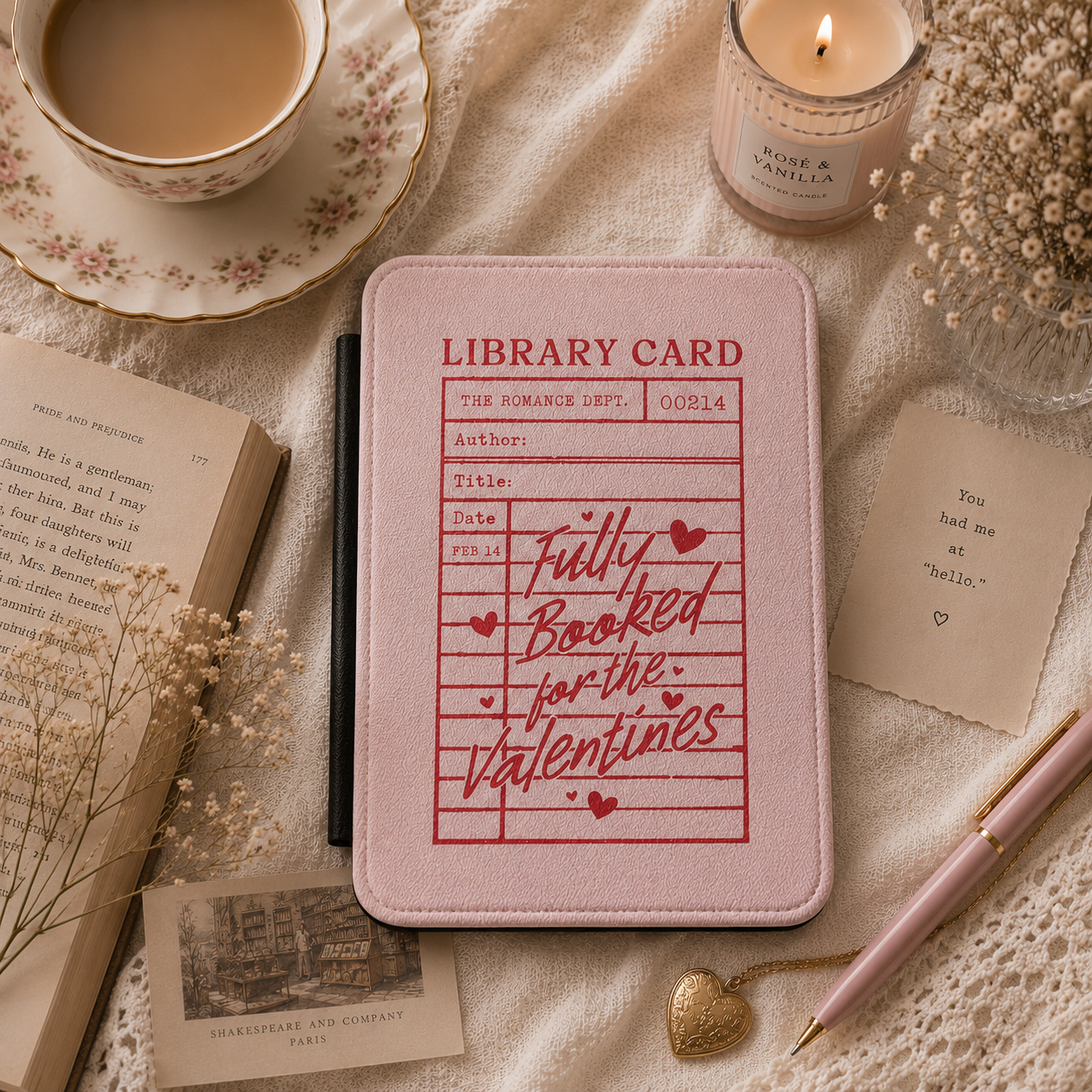 Close-up of blush pink Saffiano Fully Booked for the Valentines Kindle case with red library-card print