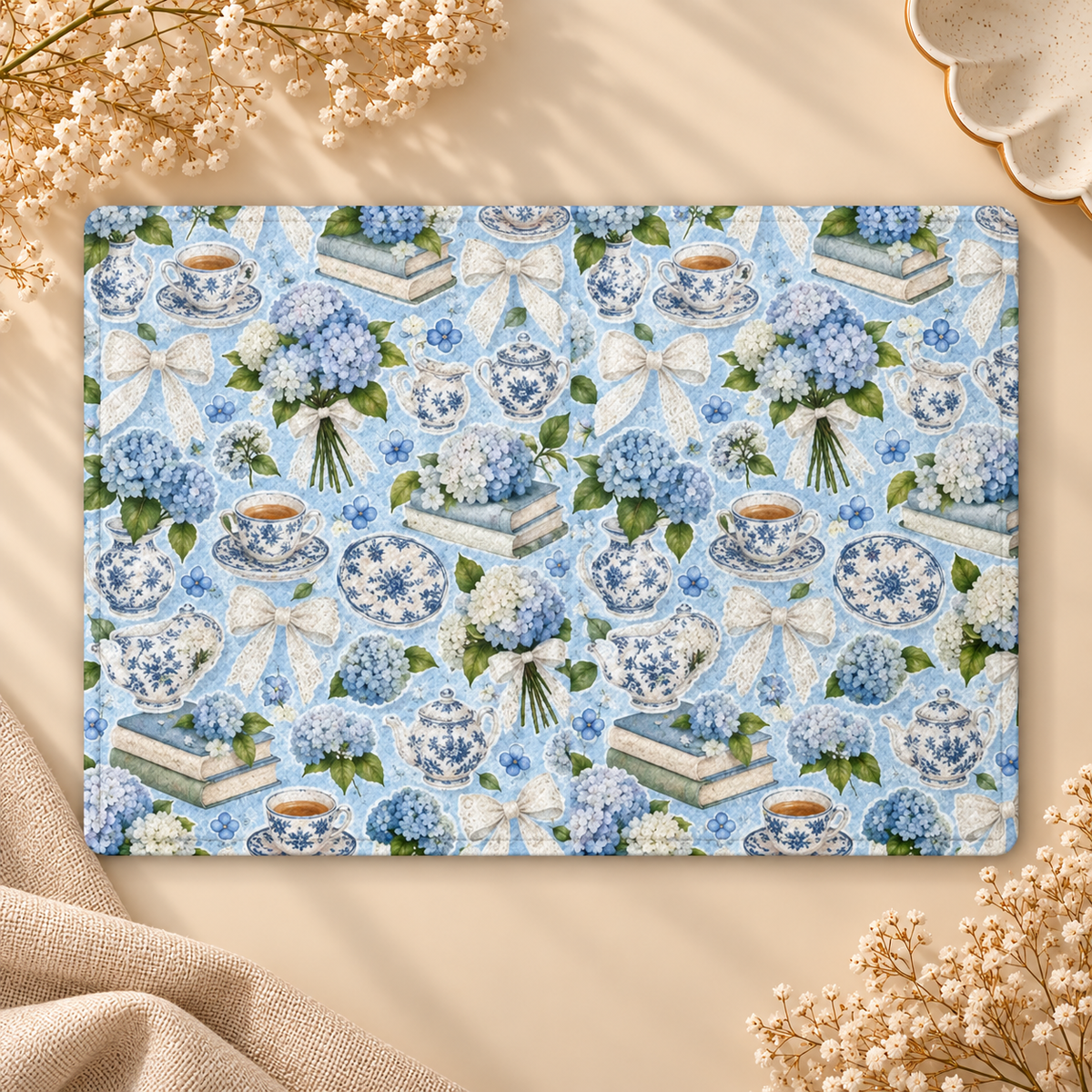 Hydrangea Tea Party Kindle case opened flat, front and back — hydrangeas, teapots, books and lace bows on sky blue
