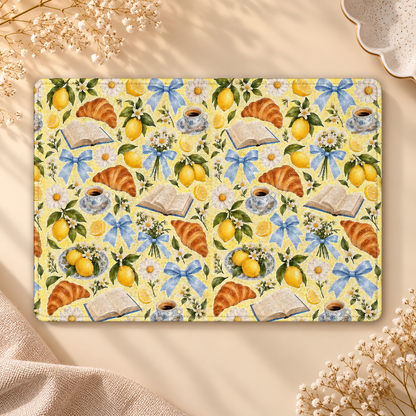 Lemons & Croissants Kindle case opened flat, front and back — lemons, croissants, open books and blue bows on yellow