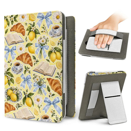 Lemons & Croissants Kindle case — elastic hand strap and fold-out stand on the back