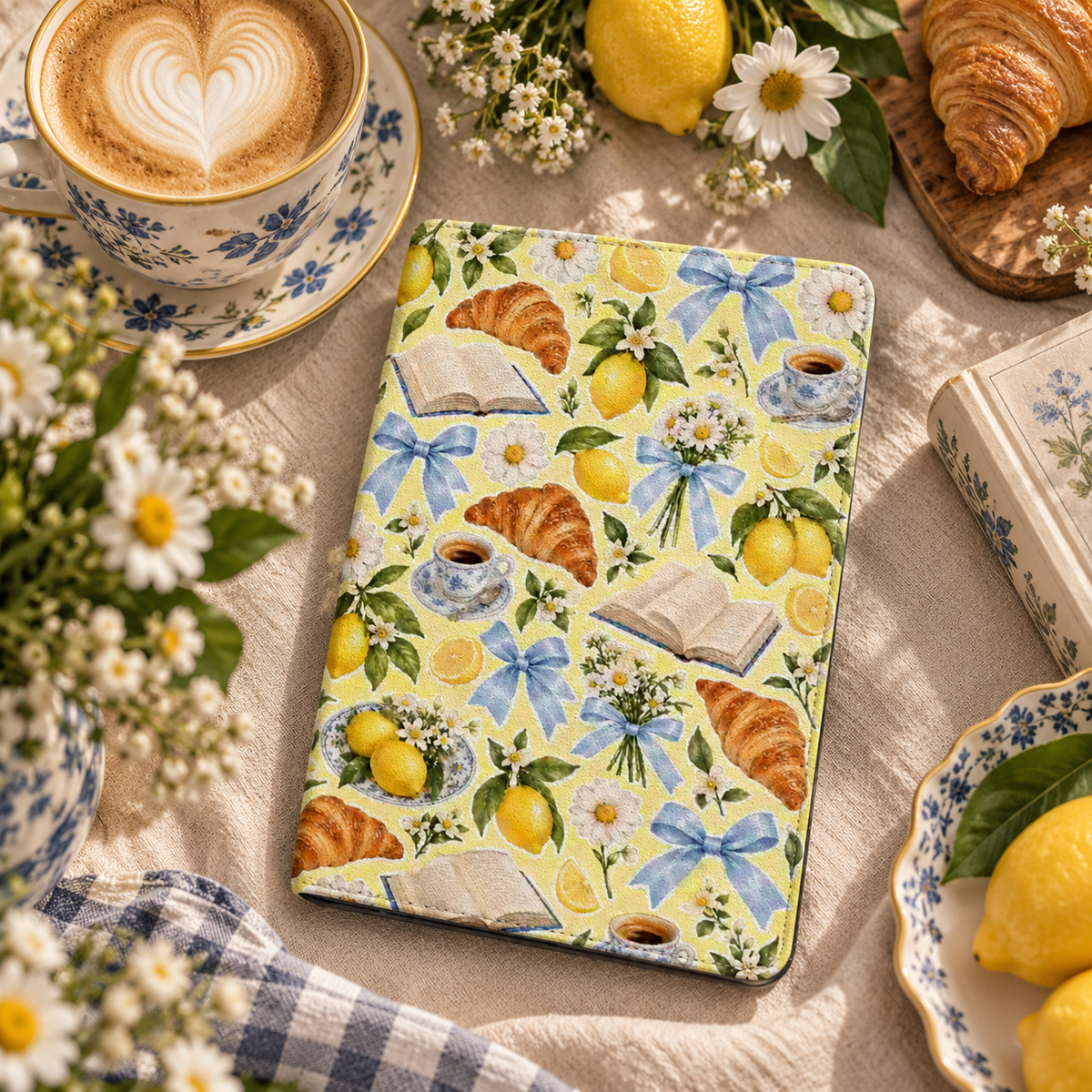 Lemons & Croissants Kindle case — lemons, croissants and blue bows on yellow, styled with a latte, daisies and fresh lemons
