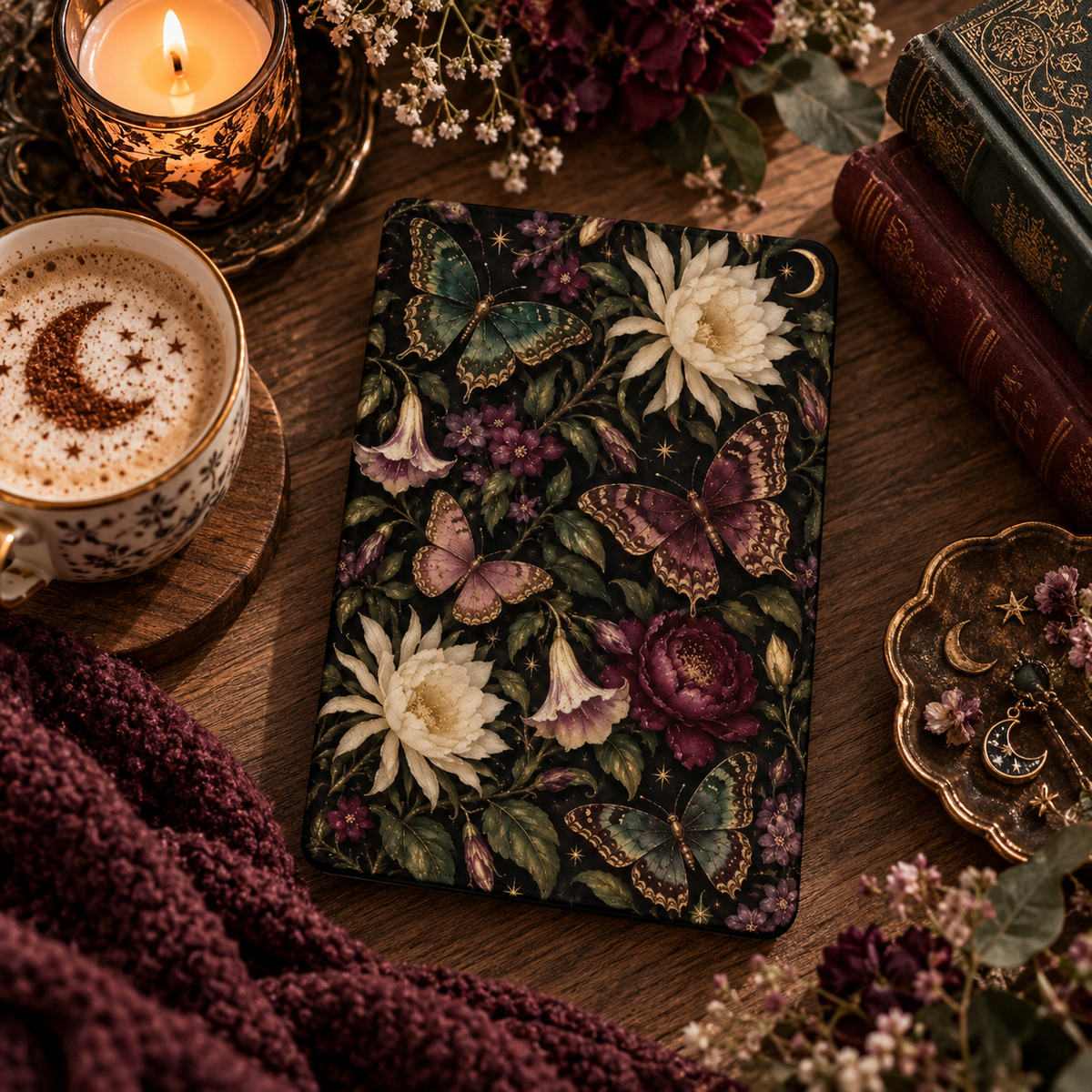 Midnight Butterfly Garden Kindle case — butterflies and night flowers on black, styled with a latte, candle and old books