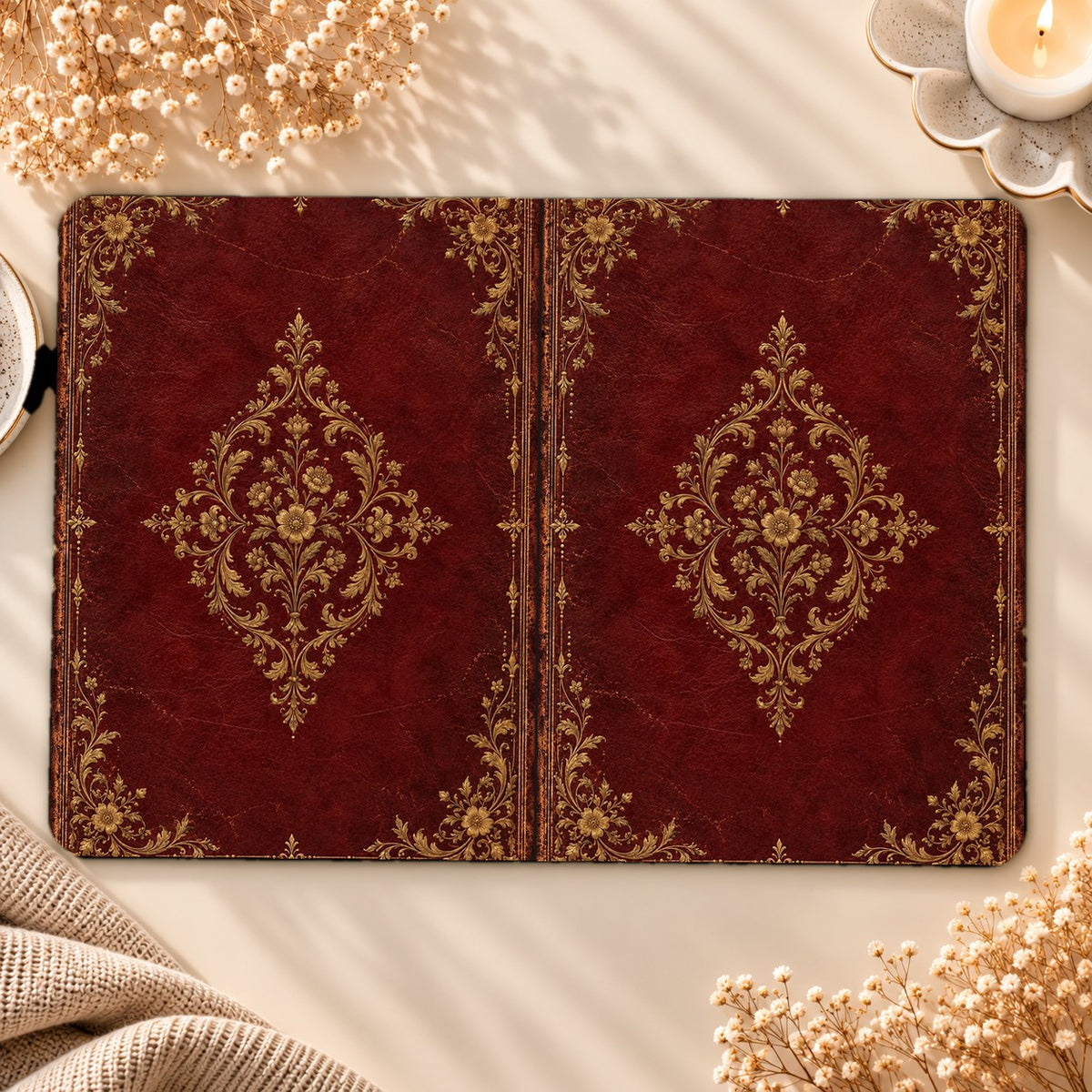 Oxblood Gilded Binding Kindle case opened flat, front and back — gold-tooled filigree medallion on oxblood