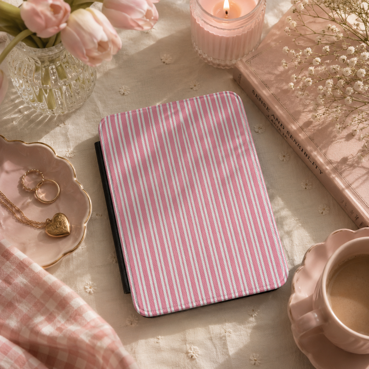 Pink candy stripe Kindle case open showing black interior — Coquette Reader ticking print