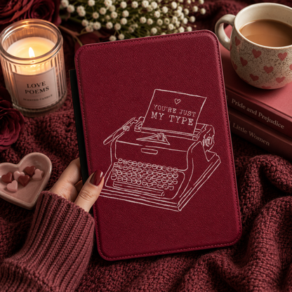 Close-up of burgundy Saffiano You're Just My Type Kindle case with white typewriter line art